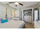 Bedroom featuring a queen bed, nautical décor, a closet with custom shelving, and wood laminate flooring at 1808 Gray S St, Gulfport, FL 33707