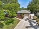 Well-maintained home with a paved driveway, lush landscaping, and a neatly manicured lawn, showcasing curb appeal at 1808 Gray S St, Gulfport, FL 33707