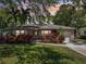 Charming home with a lush front yard, mature trees, and a cozy front porch, creating a welcoming and inviting atmosphere at 1808 Gray S St, Gulfport, FL 33707