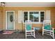 Inviting front porch with white rocking chairs and decorative pillows at 1808 Gray S St, Gulfport, FL 33707
