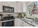 Bright kitchen features stainless steel appliances and granite countertops at 1808 Gray S St, Gulfport, FL 33707