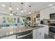 Bright kitchen features stainless steel appliances, granite countertops, and an island with breakfast bar at 1808 Gray S St, Gulfport, FL 33707
