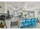 Bright kitchen features stainless steel appliances, granite countertops, an island with breakfast bar, and stylish blue bar stools at 1808 Gray S St, Gulfport, FL 33707