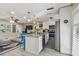 Bright kitchen features stainless steel appliances, granite countertops, an island with breakfast bar, and stylish blue bar stools at 1808 Gray S St, Gulfport, FL 33707