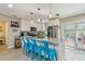 Bright kitchen features stainless steel appliances, granite countertops, an island with breakfast bar, and stylish blue bar stools at 1808 Gray S St, Gulfport, FL 33707