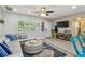 Bright living room featuring hardwood floors, large windows, and comfortable seating area at 1808 Gray S St, Gulfport, FL 33707