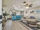 Open concept living room with stylish decor and adjacent kitchen featuring blue bar stools at 1808 Gray S St, Gulfport, FL 33707