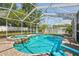 Gorgeous screened-in pool and hot tub surrounded by brick paving and lush landscaping, creating a private oasis at 1808 Gray S St, Gulfport, FL 33707