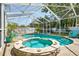 Inviting screened-in pool and spa with brick paving and poolside seating, perfect for outdoor relaxation and entertaining at 1808 Gray S St, Gulfport, FL 33707