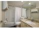 This well-lit bathroom offers a granite vanity, tile shower-tub combo, and linen storage at 1810 Mariner Dr # 207, Tarpon Springs, FL 34689