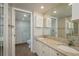 Bathroom featuring dual sink vanity and updated walk-in shower at 1810 Mariner Dr # 207, Tarpon Springs, FL 34689