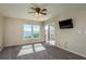 Bedroom features a ceiling fan, and a sliding glass door leading to a private balcony with beautiful scenic view at 1810 Mariner Dr # 207, Tarpon Springs, FL 34689