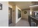 Well-lit hallway with unit number, neutral paint and an exit sign at 1810 Mariner Dr # 207, Tarpon Springs, FL 34689