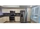 Bright kitchen features modern stainless steel appliances, including a large refrigerator and ample cabinet space at 1810 Mariner Dr # 207, Tarpon Springs, FL 34689