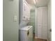 Convenient laundry area with a stacked washer and dryer unit, plus organized storage space with shelving at 1810 Mariner Dr # 207, Tarpon Springs, FL 34689