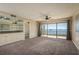 Living room with custom bar area and sliding glass doors to balcony at 1810 Mariner Dr # 207, Tarpon Springs, FL 34689