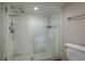 Bright walk-in shower with tile surround and glass enclosure at 1810 Mariner Dr # 207, Tarpon Springs, FL 34689