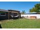 Spacious backyard includes a hammock, patio furniture, and hot tub at 1828 Stancel Dr, Clearwater, FL 33764