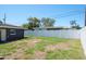 Wide backyard features a lush lawn and a solid white fence at 1828 Stancel Dr, Clearwater, FL 33764