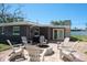 Backyard featuring a fire pit with Adirondack chairs, offering a cozy outdoor gathering space at 1828 Stancel Dr, Clearwater, FL 33764