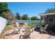 Serene backyard with a fire pit, Adirondack chairs, hot tub, and a well-maintained grassy area at 1828 Stancel Dr, Clearwater, FL 33764
