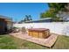 Backyard patio featuring a hot tub, Adirondack chairs, and privacy fencing at 1828 Stancel Dr, Clearwater, FL 33764