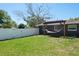 Backyard features a hammock hung from a pergola, set in a lush lawn at 1828 Stancel Dr, Clearwater, FL 33764