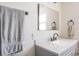 Bathroom featuring a modern sink and faucet, a mirror, and a towel rack at 1828 Stancel Dr, Clearwater, FL 33764