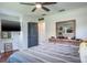 Inviting bedroom with a large TV, bed with gray and white stripes, and sports-themed decor at 1828 Stancel Dr, Clearwater, FL 33764