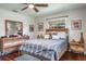 Comfortable bedroom with bed, wooden accents, ceiling fan, and natural light from the window at 1828 Stancel Dr, Clearwater, FL 33764