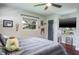 Relaxing bedroom with a plush bed, sports-themed decor, television, and ample natural light at 1828 Stancel Dr, Clearwater, FL 33764