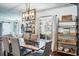 Dining room with stylish light fixture, shelving, large windows, and an open concept living space at 1828 Stancel Dr, Clearwater, FL 33764