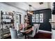 Dining room with stylish light fixture, dark accent wall, shelving and black and wood table at 1828 Stancel Dr, Clearwater, FL 33764