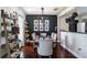 Contemporary dining room with stylish light fixture and dark accent wall at 1828 Stancel Dr, Clearwater, FL 33764