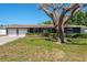 Charming single-story home featuring an attached two-car garage and a well-maintained lawn at 1828 Stancel Dr, Clearwater, FL 33764
