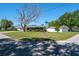 Home on a corner lot featuring a mature tree in the front yard at 1828 Stancel Dr, Clearwater, FL 33764