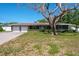Charming single-story home featuring an attached two-car garage and a well-maintained lawn at 1828 Stancel Dr, Clearwater, FL 33764