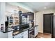 Open concept kitchen with granite countertops and a hanging pot rack at 1828 Stancel Dr, Clearwater, FL 33764