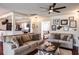 A neutral-toned living room showcases dark wood floors, ceiling fan and an open concept floor plan at 1828 Stancel Dr, Clearwater, FL 33764