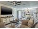 A living room with a large window lets in natural light, complementing the dark wood floors at 1828 Stancel Dr, Clearwater, FL 33764