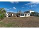 Home's exterior backyard view with the water out back and grass at 1863 Venetian Point Dr, Clearwater, FL 33755