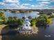 Aerial view of a waterfront community featuring a scenic gazebo and fountain in the middle of the community lake at 19212 Iron Topsail Isle, Land O Lakes, FL 34638