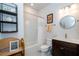 Bright bathroom with a vanity, toilet, shower with curtain, and decorative shelf at 19212 Iron Topsail Isle, Land O Lakes, FL 34638