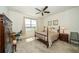 A relaxing bedroom with water views, a ceiling fan, neutral colors, and traditional wood furniture at 19212 Iron Topsail Isle, Land O Lakes, FL 34638