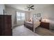 Comfortable bedroom featuring neutral tones, carpet, and a window overlooking a peaceful lake at 19212 Iron Topsail Isle, Land O Lakes, FL 34638