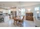 Bright and open dining area connected to the kitchen, featuring a wooden table, chairs, and ample natural light at 19212 Iron Topsail Isle, Land O Lakes, FL 34638