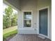 Inviting front entrance with a stylish blue door, brick walkway, and manicured landscaping at 19212 Iron Topsail Isle, Land O Lakes, FL 34638