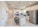Modern kitchen featuring an island, stainless steel appliances, and bright white cabinets at 19212 Iron Topsail Isle, Land O Lakes, FL 34638