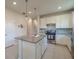 Open kitchen featuring a granite island, stainless appliances, and white cabinetry at 19212 Iron Topsail Isle, Land O Lakes, FL 34638