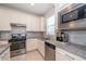 Well-equipped kitchen with stainless steel appliances, granite countertops, and ample cabinet space for modern convenience at 19212 Iron Topsail Isle, Land O Lakes, FL 34638